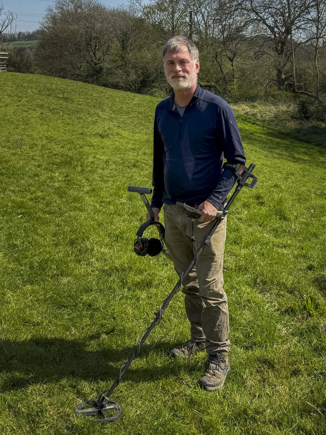 Hugo metal detecting in a Cotswolds field